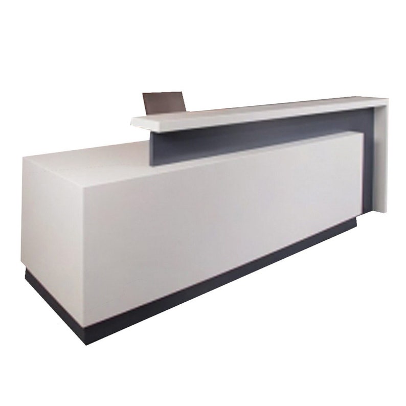 May include: White reception desk with a gray countertop and a curved front edge. The desk has a built-in shelf and a small ledge on the top.