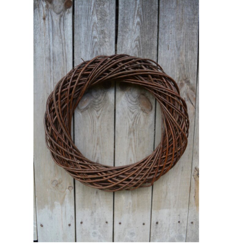 May include: A brown woven wreath made of natural twigs, perfect for decorating a door or wall.