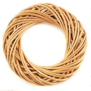 May include: A natural woven wreath made of light brown wicker. The wreath is round and has a diameter of approximately 12 inches.