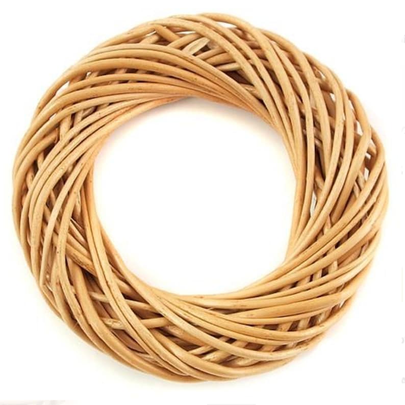 May include: A natural woven wreath made of light brown wicker. The wreath is round and has a diameter of approximately 12 inches.