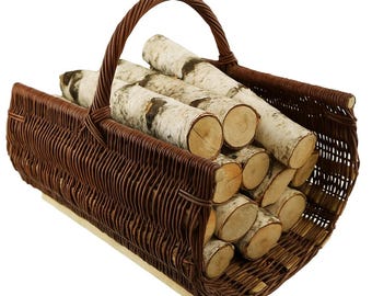 May include: A brown wicker basket filled with birch logs. The basket has a curved handle and is made of woven brown material. The birch logs have a white and black bark.