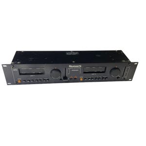 May include: A black Numark CD5000 dual CD player. The unit has two CD player slots, a central control panel, and various buttons and knobs. The Numark logo is visible on the top center of the unit.
