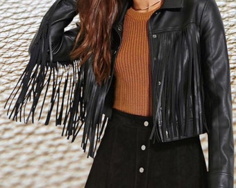 May include: Black faux leather jacket with fringe detailing. The jacket has a snap closure and a button-up front.