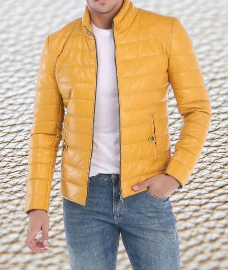 May include: A yellow quilted leather jacket with a zipper closure. The jacket has a stand-up collar and a slightly fitted silhouette.