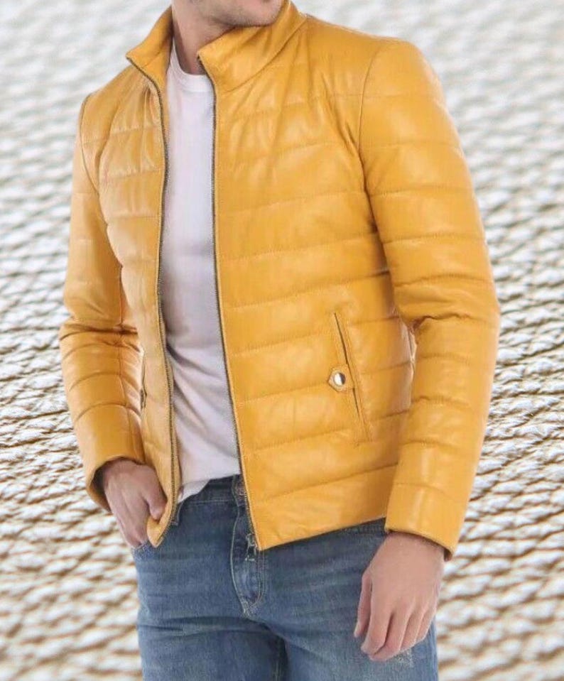 May include: A yellow quilted leather jacket with a zipper closure. The jacket has a stand-up collar and a pocket on the left side.