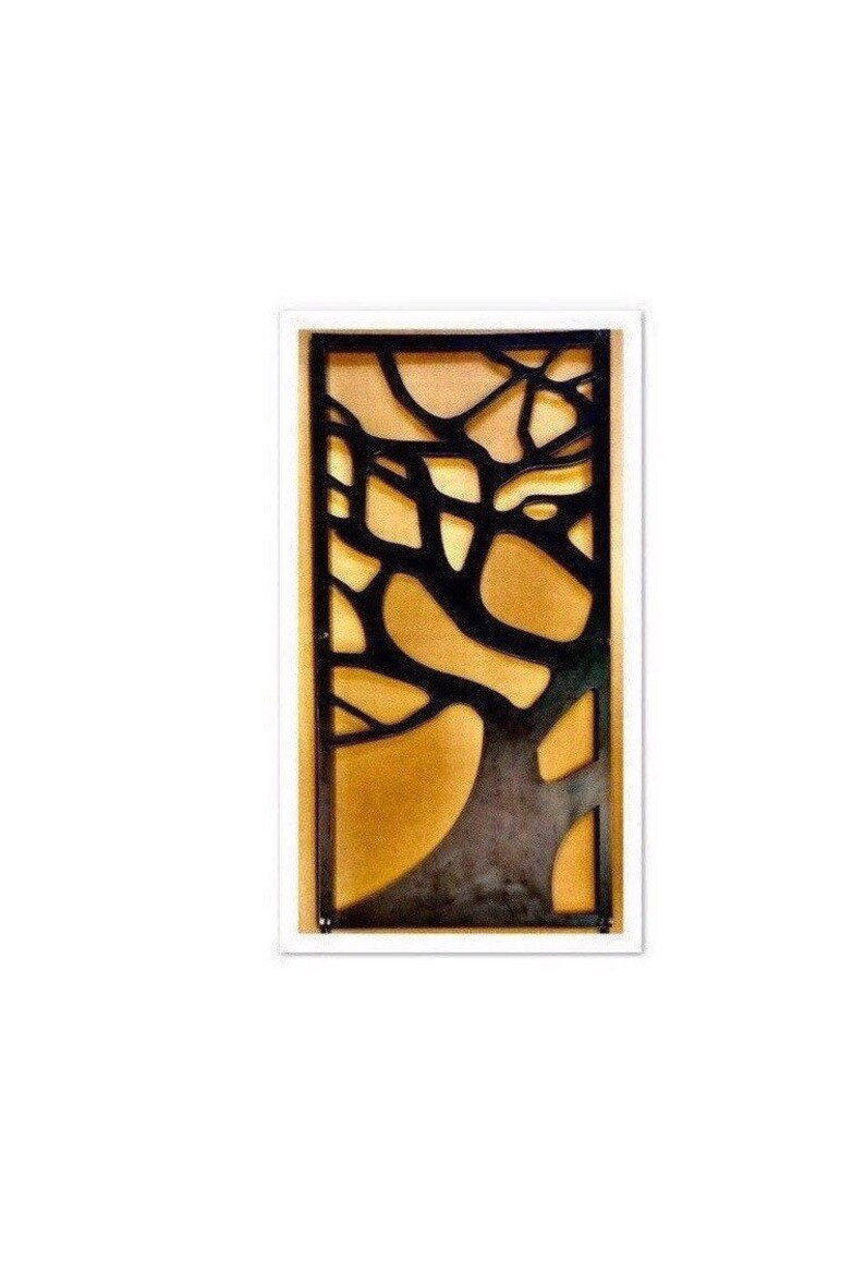 May include: A black metal wall decor with a tree branch design. The background is a light brown color.