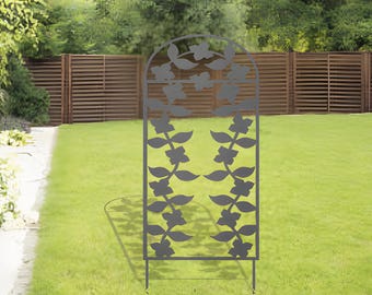 May include: Black metal garden trellis with a decorative floral design. The trellis is freestanding and has two stakes for stability.