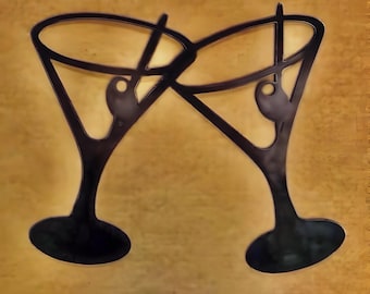 May include: Two black metal martini glasses clinking together, a decorative wall art piece.