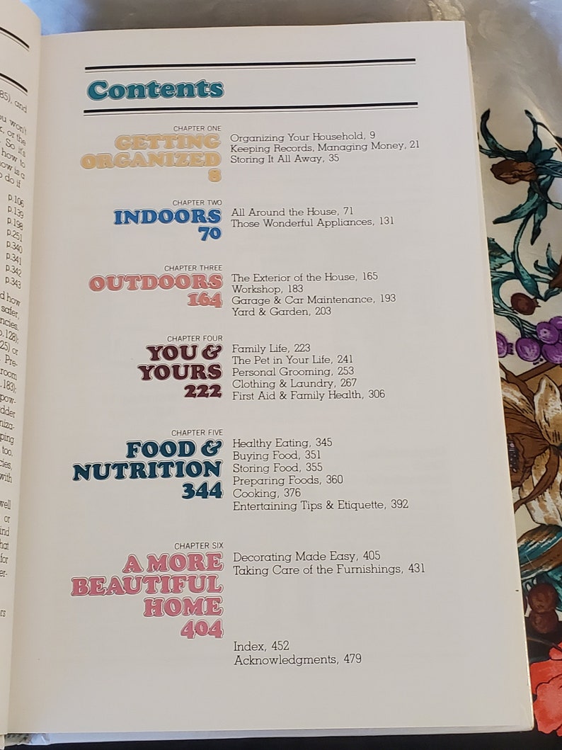 May include: A book titled "Getting Organized" with a table of contents listing chapters on organizing your household, indoors, outdoors, you and yours, food and nutrition, and a more beautiful home. The book cover is a light brown with a peach colored title and chapter headings.