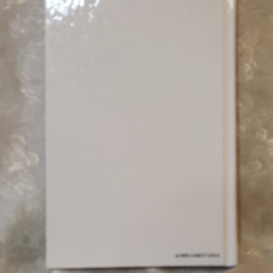 May include: White blank book cover with a glossy finish.