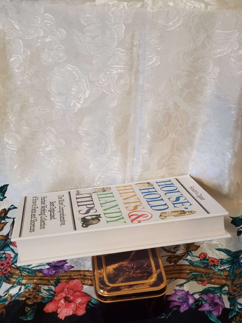 May include: A white book titled "House Hold Hints & Handy Tips" with the text "The Most Comprehensive, Best Organized, Hardest Working Collection of How-to Facts and Shortcuts" on the cover.