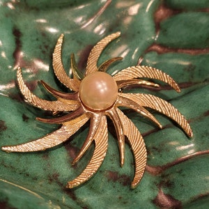 Gold Tone Starburst Brooch with Faux Pearl