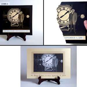 May include: A black and white photograph of a clock tower with two people standing in front of it. The photo is framed in a black frame and has a white mat. The photo is on a wooden easel. The text on the photo reads "THE NEW CLOCK SEPTEMBER 5, 1885".