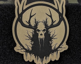 May include: A tan morale patch featuring a black graphic of a skull with large antlers and tree-like branches. The design is enclosed in a circular border. The text WENDIGO MORALE PATCH and Wendigo Algonquian Folklore is printed above and below the patch.