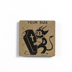 May include: A square, tan-colored graphic features a cartoon devil holding a coffin with a cross. The devil has horns, a tail, and a wide grin. The text "YOUR SIZE" is printed above the devil.