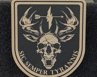 May include: A tan and black morale patch featuring a central deer skull with large antlers. Above the skull is a horizontal arrow and a lightning bolt. The text "SIC SEMPER TYRANNIS" is printed in a curved arc along the bottom edge.
