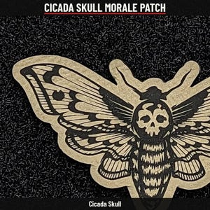 May include: A tan and black morale patch featuring a moth-like insect with a skull pattern on its thorax and detailed wing markings. The text CICADA SKULL MORALE PATCH and Cicada Skull is printed in white on the top and bottom borders.