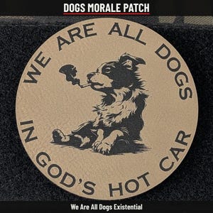 May include: A circular tan morale patch featuring a black graphic of a dog smoking a pipe. The text "WE ARE ALL DOGS IN GOD'S HOT CAR" is printed in a circular pattern around the dog. The patch has a textured surface and dark edges.