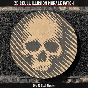 May include: A circular morale patch featuring a 3D skull illusion design in tan and black. The graphic consists of diagonal lines that form the shape of a human skull. The text 3D SKULL ILLUSION MORALE PATCH and 80s 3D SKULL ILLUSION are visible.