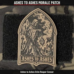 May include: A morale patch featuring a tan and black illustration of a hooded figure holding a censer in a graveyard. The design is framed in an archway with the text ASHES TO ASHES at the bottom. The patch is set against a black hook-and-loop backing.