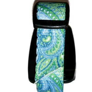 May include: A blue and green paisley patterned dog collar with a black plastic buckle.