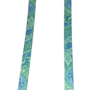 May include: Two patterned straps with black buckles, one measuring 9.5 inches and the other 11 inches.