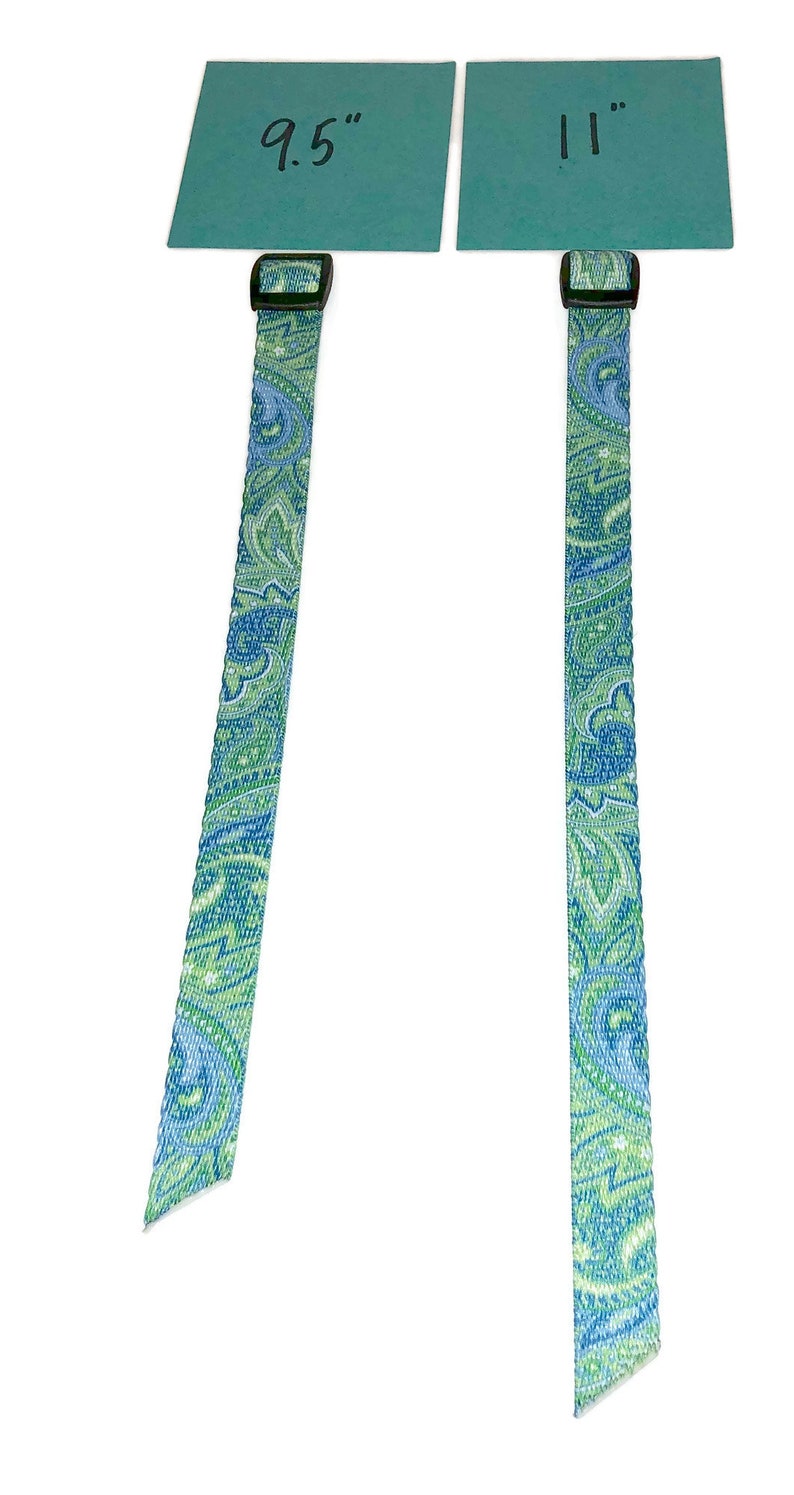 May include: Two patterned straps with black buckles, one measuring 9.5 inches and the other 11 inches.