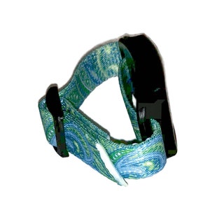 May include: A blue and green patterned adjustable wrist strap with a black plastic buckle.