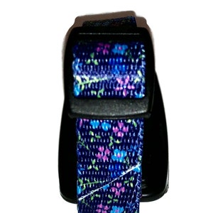 May include: A black and blue adjustable collar with a floral pattern. The collar has a plastic buckle.