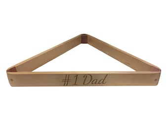 May include: Wooden billiard triangle rack with the text "#1 Dad" engraved on the base.