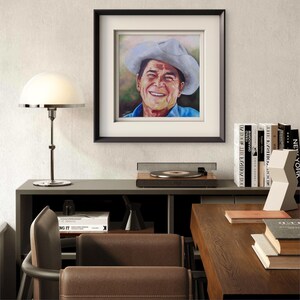 President Ronald Reagan
Titled “Power To The People”
Museum-Quality Fine Art Prints on Canvas & Archival Paper 
from an Original Hand-Painted Artwork by Marnie Miller (Texas, b. 1971)

This warm, charismatic portrait captures President Ronald Reagan in a way few images ever have—not as a distant politician, but as the genuine, approachable man the world came to love. Dressed in his iconic ranch attire, wearing a cowboy hat and faded Wrangler denim shirt, Reagan appears relaxed, confident smile.