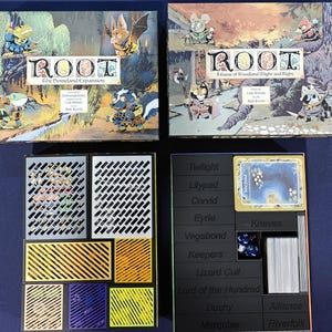May include: Two board game boxes labeled "ROOT" with woodland creature illustrations. One box is "The Homeland Expansion." Below are game components, including a black organizer with faction names and dice, and a multi-colored insert.