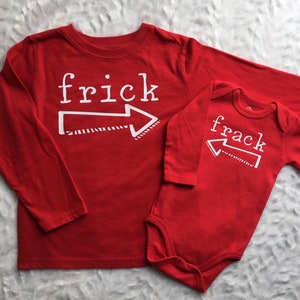 May include: Two red long-sleeved shirts with white text and arrows. The larger shirt says "frick" and the smaller shirt says "frack".