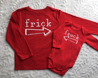 May include: Two red long-sleeved shirts with white text and arrows. The larger shirt says "frick" and the smaller shirt says "frack".