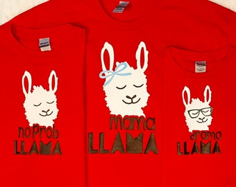 May include: Three red t-shirts with llama illustrations and text. The first shirt says "no prob llama", the second shirt says "mama llama", and the third shirt says "drama llama".