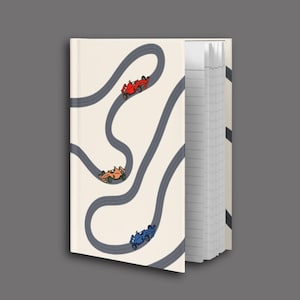 May include: A notebook with a cream-colored cover featuring a race track design with three colorful race cars. The cars are red, orange, and blue. The notebook's pages are lined.