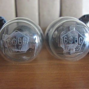 May include: Two clear glass vacuum tubes with a hexagonal label that reads "606C" on each. The label on the left tube also has the text "VI. 6" and the label on the right tube has the text "IP 22".