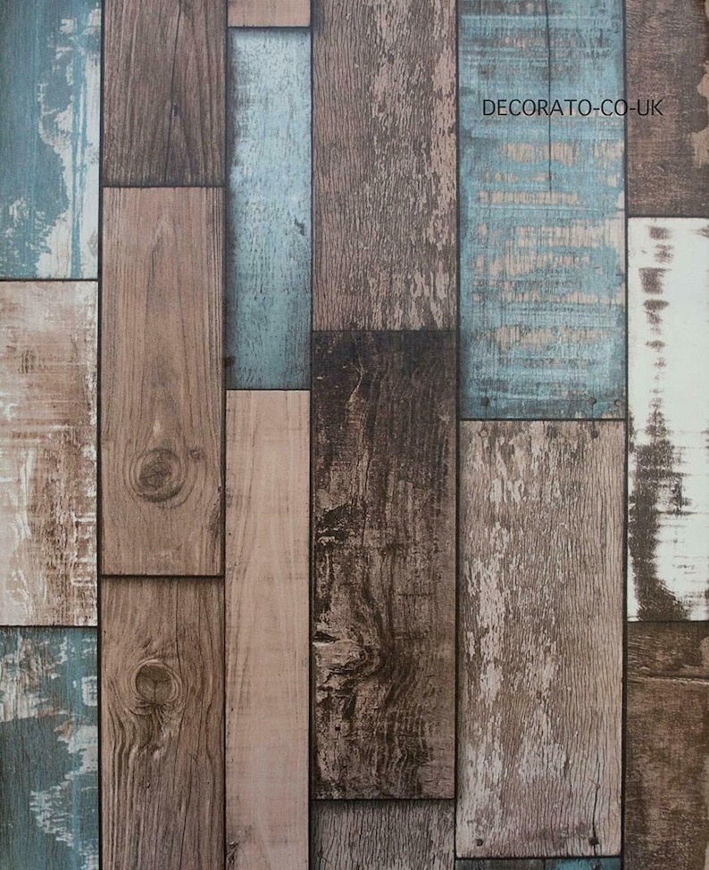 May include: A wood-look wallpaper with a rustic design featuring a variety of wood tones, including brown, beige, and blue. The wallpaper has a distressed look, giving it a vintage feel. The text "DECORATO-CO-UK" is printed in the upper right corner.