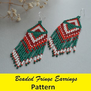 May include: A pair of beaded fringe earrings. The earrings feature a triangular top with a pattern of white, red, and green beads. Long fringe hangs from the bottom, with alternating rows of red, white, and green beads. The earrings have silver-colored hooks.