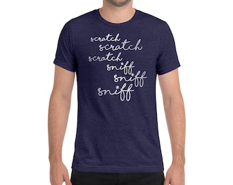 May include: A navy blue t-shirt with the words "scratch" and "sniff" written in white cursive.