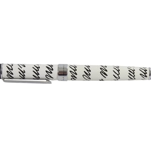 May include: A white pen with a silver clip and black ink. The pen is covered in a repeating pattern of black cursive writing.