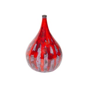 May include: A teardrop-shaped ceramic vase with a glossy red glaze. Vertical streaks of purple and brown run down the sides. The vase has a narrow neck and a dark rim. The vase is a decorative home decor item.