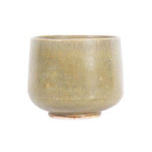 May include: A ceramic cup with a smooth, muted olive-green glaze and a subtle speckled texture. The vessel features a rounded, cylindrical body that tapers slightly toward a small, unglazed circular base with a visible reddish-brown clay rim.