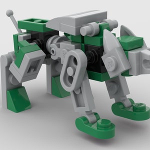 May include: A Lego model of a robotic animal, primarily green and gray. The toy animal has a boxy body, articulated legs, and a tail. The head features a stylized design with a pointed ear and a small, round antenna. The model is constructed from interlocking plastic bricks.