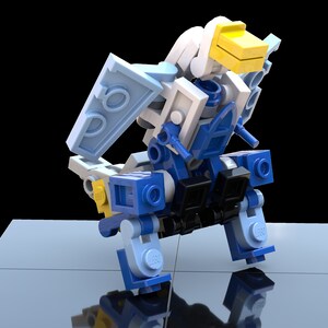 May include: A blue and white Lego robot with yellow accents. The robot has a bird-like head and is standing on a blue surface.