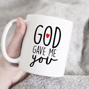 May include: White ceramic coffee mug with black text that reads "GOD gave me you" with a small red heart in the word "GOD".