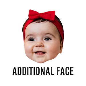 May include: A close-up of a baby's face with a red bow headband. The baby is smiling and looking at the camera.