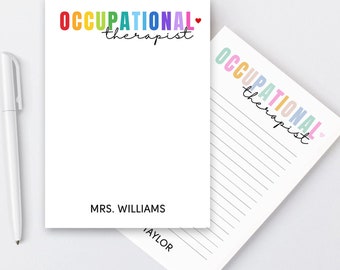 May include: A notepad with a rainbow colored "Occupational Therapist" title and a red heart. The notepad has lined pages and a blank page with the name "MRS. WILLIAMS" printed at the bottom.