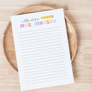 May include: A white printable note paper with lined paper and a yellow pencil with a pink eraser. The text at the top reads "a little note from MRS. JOHNSON" in colorful letters.