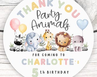 May include: A round sticker with the text "THANK YOU Party Animals" and "FOR COMING TO CHARLOTTE'S 5th BIRTHDAY". The sticker features illustrations of a zebra, elephant, giraffe, lion, and hippo, with balloons.